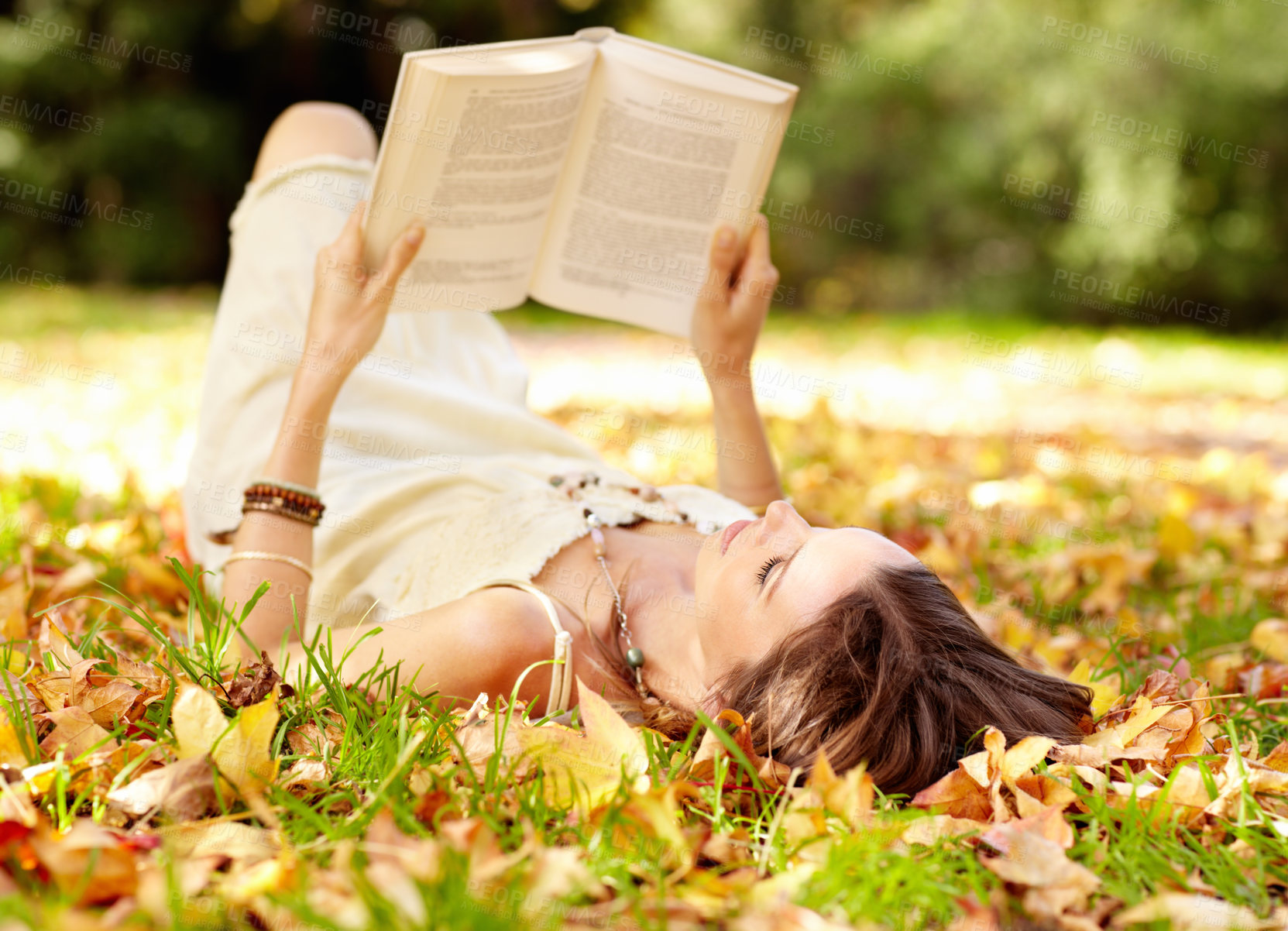 Buy stock photo Shot of an attractive young woman in the park on an autumn day