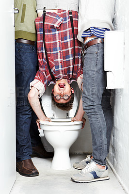 Buy stock photo Geek, bully and students in a school toilet for abuse, fear or hazing of a victim in a bathroom stall. Portrait, dunk and upside down with a teen nerd embarrassed by thugs at university or college