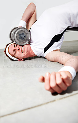 Buy stock photo Fitness, face and dumbbell with an unlucky man in the gym after an accident while lifting heavy weights. Exercise, injury or pain with a young person making a mistake during a training workout