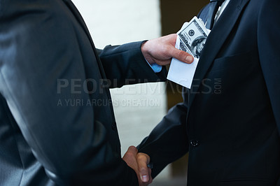 Buy stock photo Two corporate businessmen shaking hands while one man places money in the other&amp;#039;s pocket
