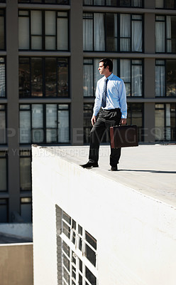 Buy stock photo Businessman, suicide and roof with stress, depression and mental health with suitcase outdoor in city. Professional, person or employee on rooftop of building with anxiety, risk, crisis or suffering