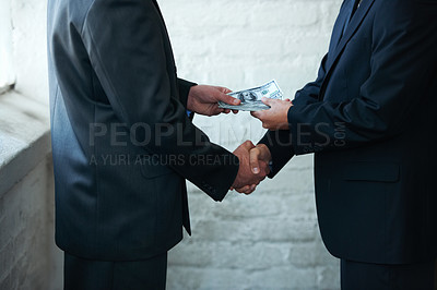 Buy stock photo Two corporate businessmen shaking hands and making a financial deal