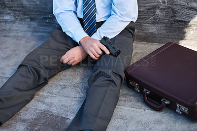 Buy stock photo Businessman, hands and gun with suicide, stress and depression on ground with suitcase for risk or problem. Professional, person or employee with weapon on floor for mental health, anxiety and sad