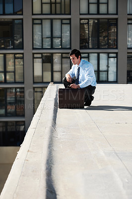 Buy stock photo Businessman, suicide or roof and thinking, depression and mental health with suitcase outdoor in city. Professional, person or employee and stress on rooftop of building with anxiety, risk and crisis