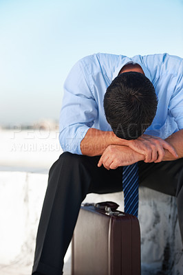 Buy stock photo Business, man and outdoor with stress, depression and mental health with suitcase on rooftop in city. Professional, person or employee on roof of building with anxiety, risk and suffering with crisis