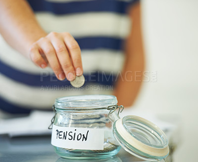 Buy stock photo A person putting a penny in a jar that is labeled &#039;Pension&#039;