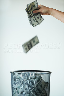 Buy stock photo Bin, money or bills with finance, inflation or debt with bankruptcy, trash or global recession. Waste bucket, cash or economy issues with fraud, corruption or value decline on a studio background