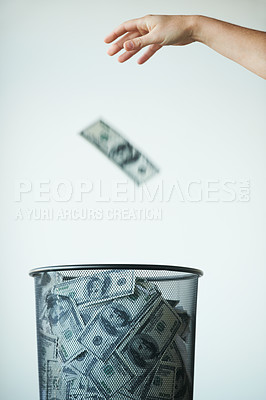 Buy stock photo Dustbin, money or bills with finance, inflation or debt with bankruptcy, trash or global recession. Waste bucket, cash or economy issues with fraud, corruption or value decline on a studio background