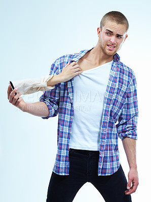 Buy stock photo A handsome young man having his shirt pulled by the hand coming out from the cellphone