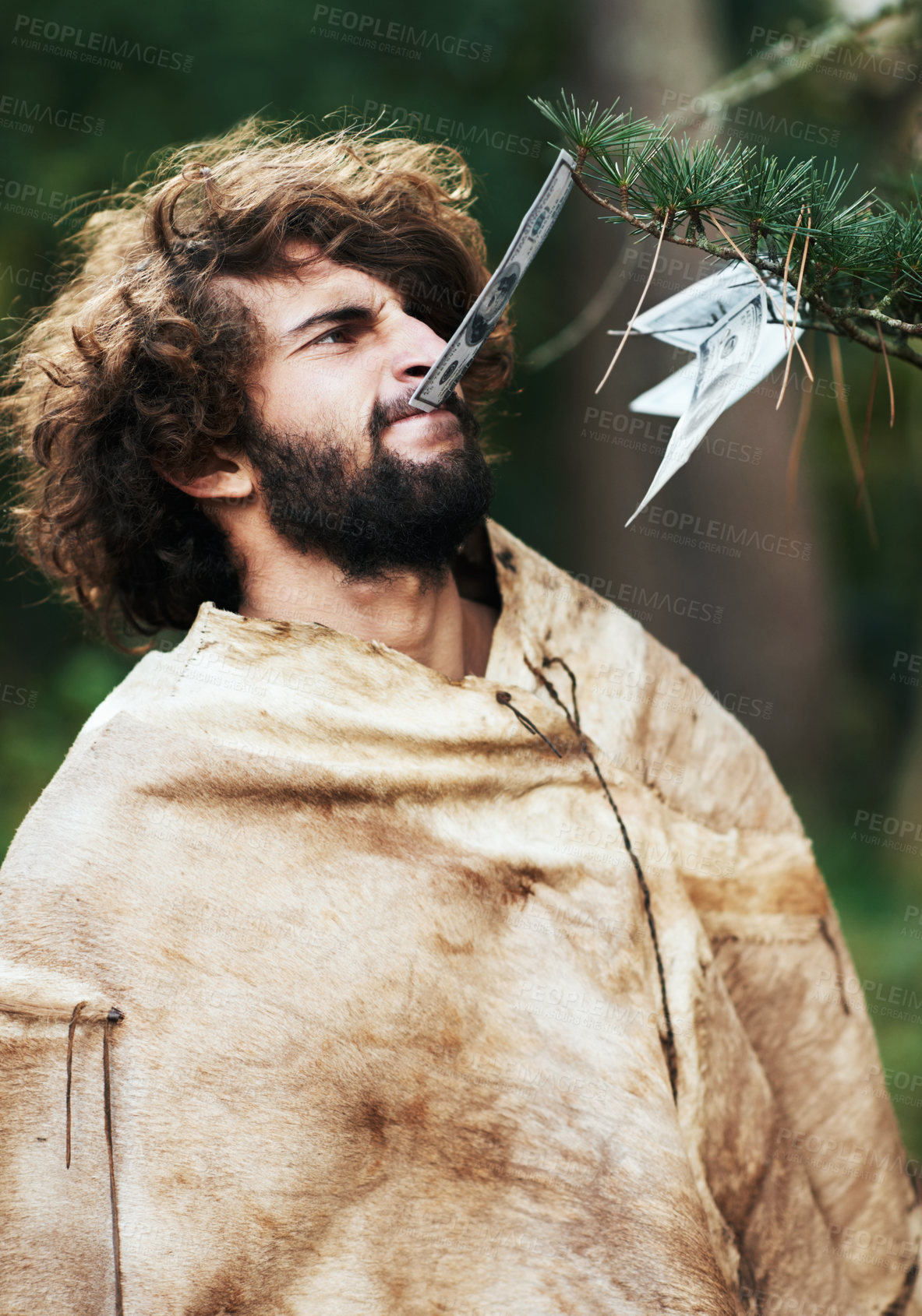 Buy stock photo Nature, confused and caveman at a tree for money, finance, or prehistoric. Frustrated, young and a person or man with a note from a leaf for currency, cash or biting financial wealth in the woods