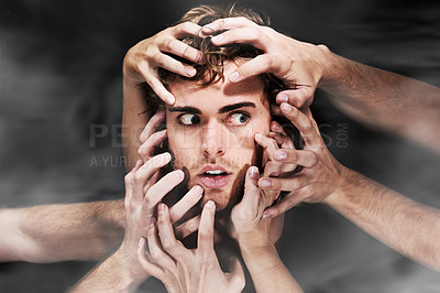 Buy stock photo Scared, schizophrenia and man with hands, mental health or bipolar in studio isolated on a black background. Face, smoke and person with fear, horror or abuse drugs, hallucination and sick fantasy