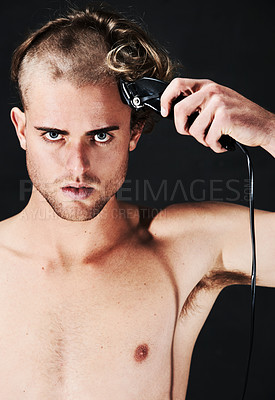 Buy stock photo Portrait, body and serious man shaving hair or head in studio isolated on a black background. Face, haircut machine and naked person at hairdresser salon with trimmer for wellness, care and hairstyle