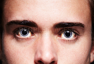 Buy stock photo Closeup portrait of a young man's face with dilated pupils