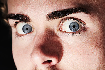 Buy stock photo Closeup portrait of a young man with wide eyes and small pupils