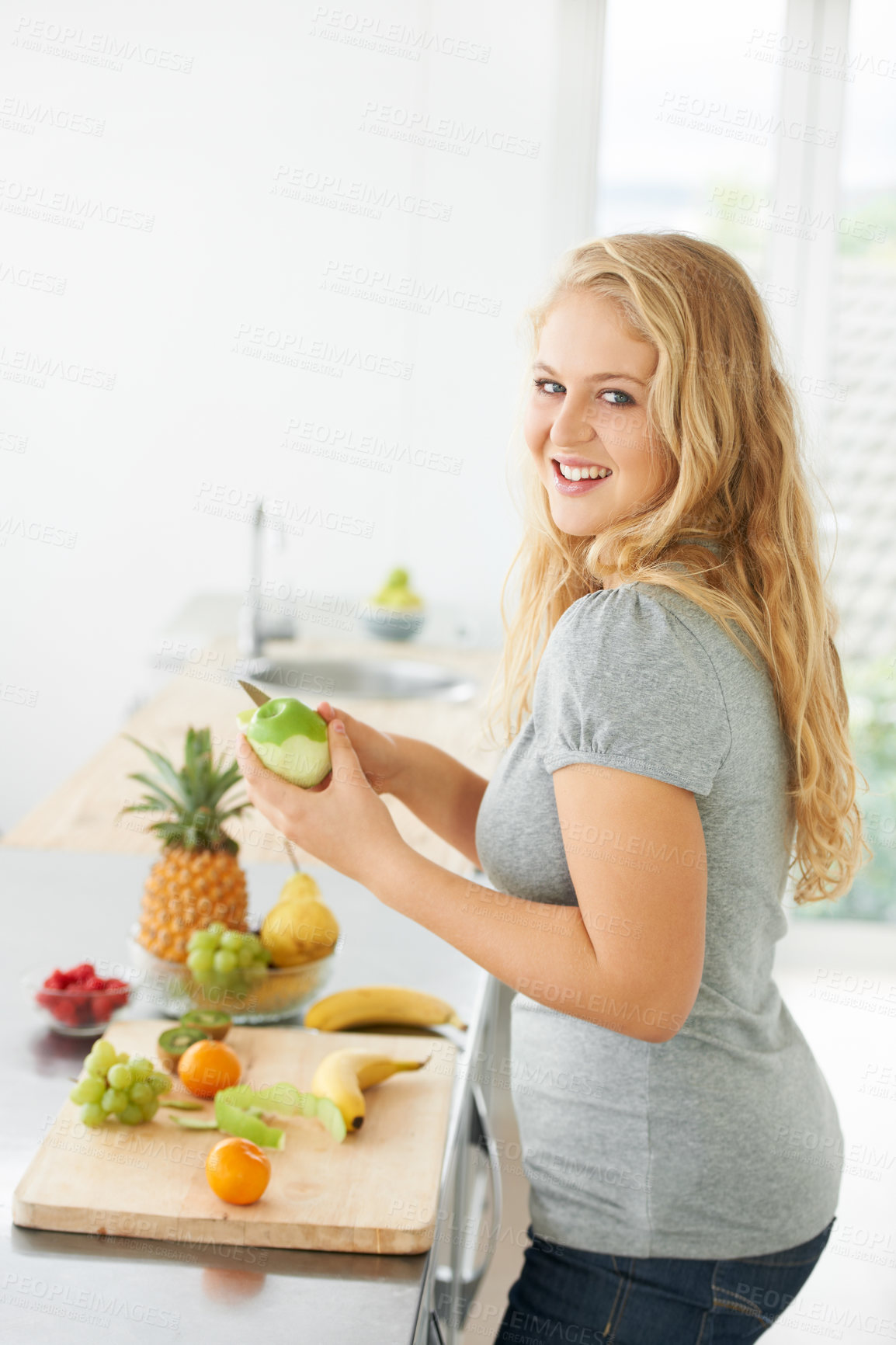 Buy stock photo Fruit, peeling apple or portrait of woman with a morning snack, breakfast meal or diet in kitchen at home. Healthy lunch, plus size or happy girl eating food to lose weight for wellness or gut health