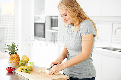 Buy stock photo Woman, cooking and fruit for health food and nutrition for weight loss diet and health at home. Kitchen, organic fruits and cut banana in a house with breakfast and nutritionist in the morning