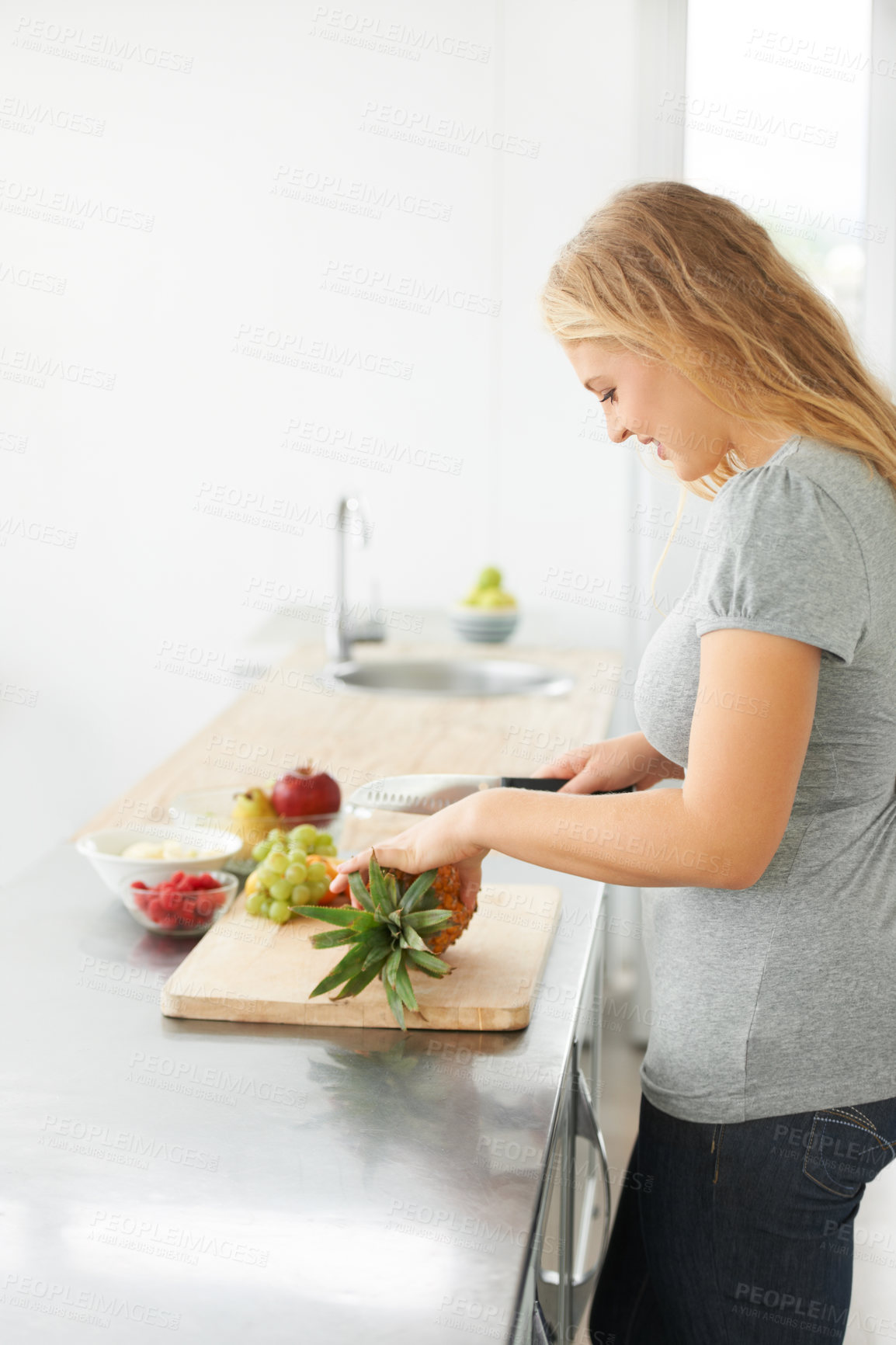 Buy stock photo Woman, healthy cooking and fruit for eating food and nutrition for weight loss diet and health at home. Kitchen, cut fruits and produce in a house with breakfast and nutritionist in the morning