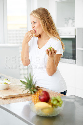 Buy stock photo Fruits, eating grapes or woman thinking of a healthy morning meal, lunch meal or diet in kitchen at home. Breakfast, wonder or vegan girl enjoying fruit salad or food bowl to lose weight for wellness