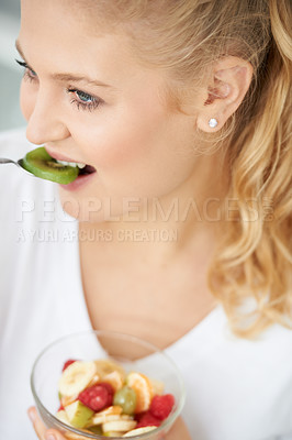 Buy stock photo Kiwi, eating or happy woman with fruit salad, morning breakfast meal or lunch diet in home kitchen. Smile, gut health or vegan girl with fruits, vitamin c or food bowl to lose weight for wellness
