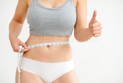Buy stock photo Lose weight, measuring tape or woman with thumbs up, success or fitness goals on white background. Measure, weightloss or girl in underwear with body target, stomach or like hand sign for wellness