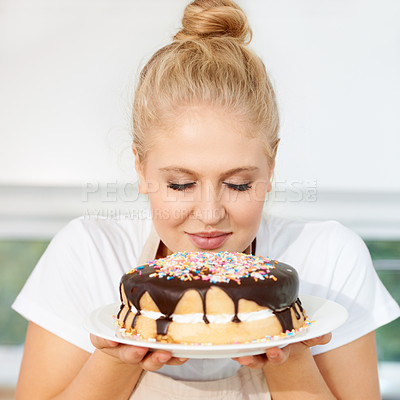 Buy stock photo Smelling, cake and girl is holding dessert for celebration with chocolate and sprinkles with scent at a bakery. Female baker, birthday and food with pastry for party or eating a sweet meal with cream