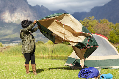 Buy stock photo Woman outdoor, tent setup to camp and adventure, nature and travel to forest or woods with environment. Camper with tarp, equipment and trip in mountains with recreation, gear for shelter and holiday