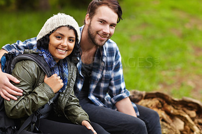Buy stock photo Couple, smile and camping in nature, backpack and sitting to enjoy, outdoor and relaxing. Dating, woman and man for happiness, wellness and relationship to explore, bonding and adventure together