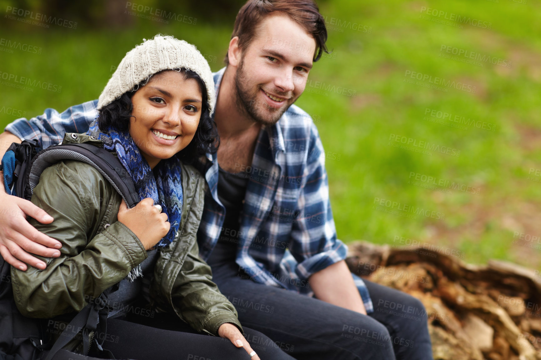 Buy stock photo Couple, smile and camping in nature, backpack and sitting to enjoy, outdoor and relaxing. Dating, woman and man for happiness, wellness and relationship to explore, bonding and adventure together
