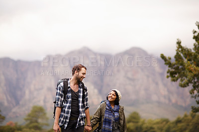 Buy stock photo Cute young couple exploring the outdoors together