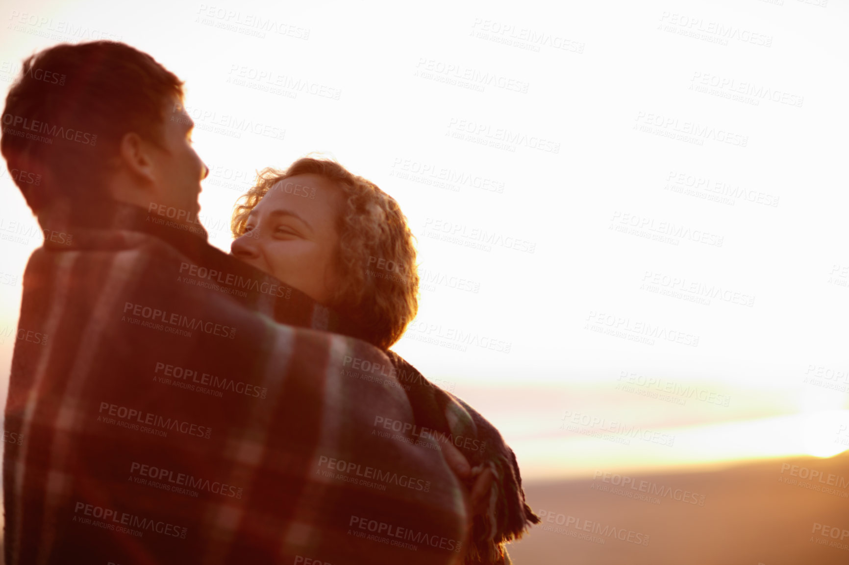 Buy stock photo Beach, sunset and love with couple hug in blanket together with joy, support and care. People, embrace and smile for morning sunrise and relax with happiness in nature on holiday or vacation mockup