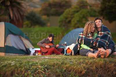 Buy stock photo Couple, outdoor and camping in park, adventure and cold together with blanket, enjoying and sitting. Travel, man and woman for relax, happiness and relationship with romance, bonding and hug
