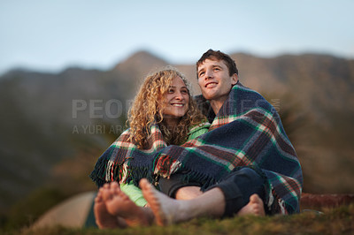 Buy stock photo Couple, outdoor and blanket for sitting, cold and camping together to enjoy, relaxing and hugging. Dating, woman and man for adventure, happiness and relationship with romance, bonding and nature