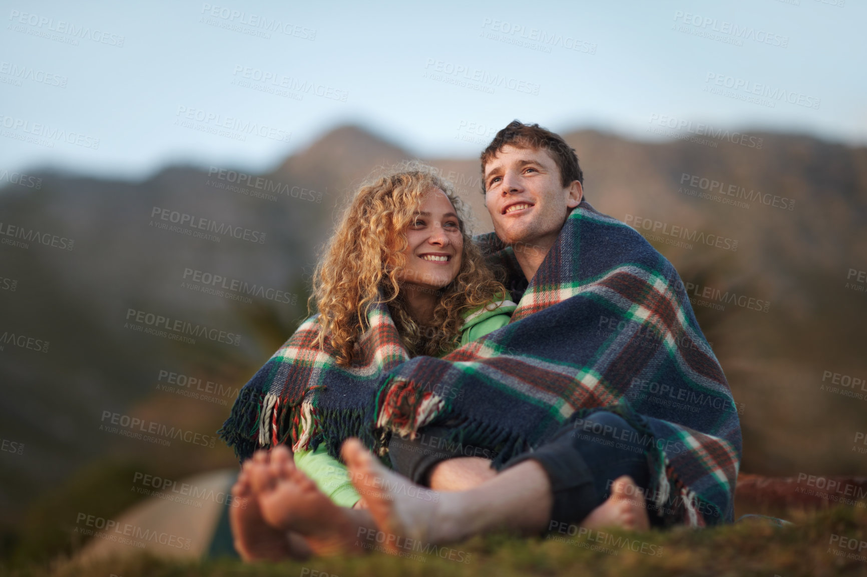 Buy stock photo Couple, outdoor and blanket for sitting, cold and camping together to enjoy, relaxing and hugging. Dating, woman and man for adventure, happiness and relationship with romance, bonding and nature