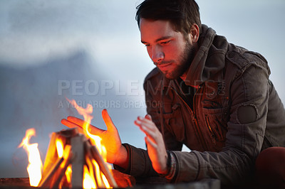 Buy stock photo Man, fire and camping with travel and outdoor in nature, warm up and winter, relax with peace and vacation. Camper, flame or campfire for heat and freedom, adventure at campsite with wood and comfort