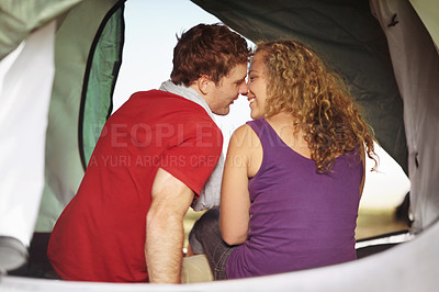 Buy stock photo Couple in tent, kiss and camping with travel, people in relationship with love and intimacy outdoor. Shelter, bonding with adventure or holiday together, trust and care, back view and happy camper