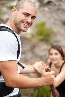 Buy stock photo Helping hand, portrait of man and woman on hiking adventure in mountain with nature, wellness or support. Travel, trekking and happy couple in countryside climbing on natural outdoor journey together