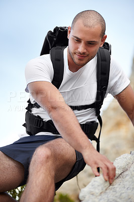 Buy stock photo Man on rock, backpack and climbing on hiking adventure in mountain with nature hike, freedom or wellness. Travel, trekking and person in countryside, natural outdoor journey and hanging on cliff.