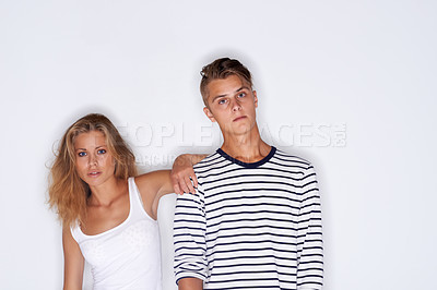 Buy stock photo Fashion, confident and portrait of couple on a white background with trendy clothes, style and cool outfit. Beauty, aesthetic and isolated man and woman in studio with serious face, attitude or pride