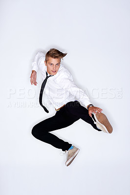Buy stock photo Portrait of a trendy young man in mid-air against a white background