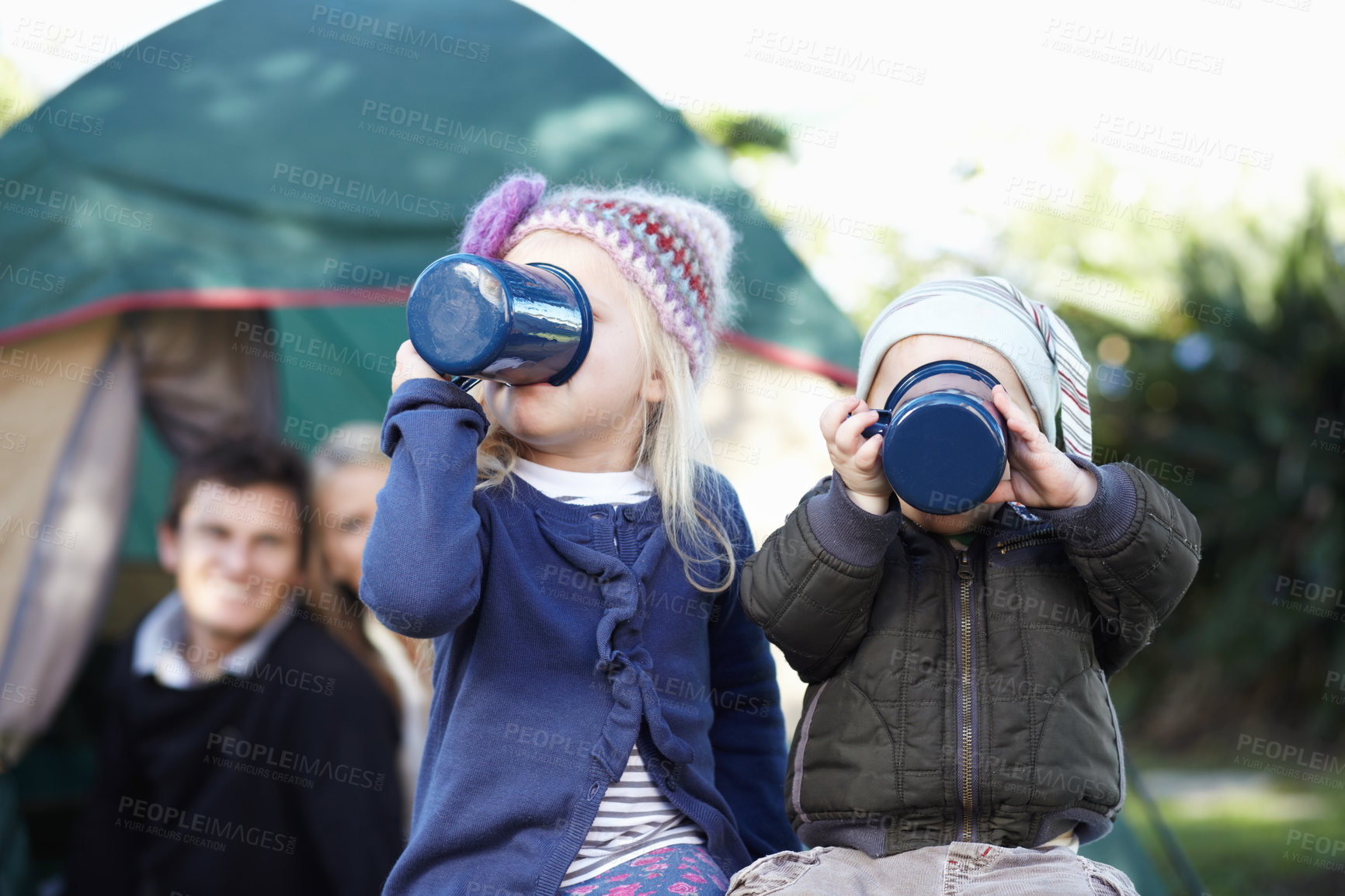 Buy stock photo Children, siblings and together for drinking while camping in Sweden, woods or forest on trip. Girl, boy and enjoyment of delicious, beverage or hot cocoa with cup, family and  adventure in nature