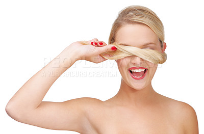 Buy stock photo A young blonde woman holding a lock of her hair over her face
