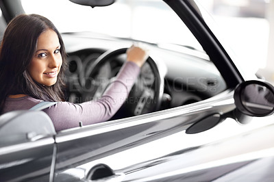 Buy stock photo Smile, dealership and portrait of woman in a vehicle for purchase with positive, good or confident attitude. Happy, driving and young female person from Canada in a new car in showroom for transport.