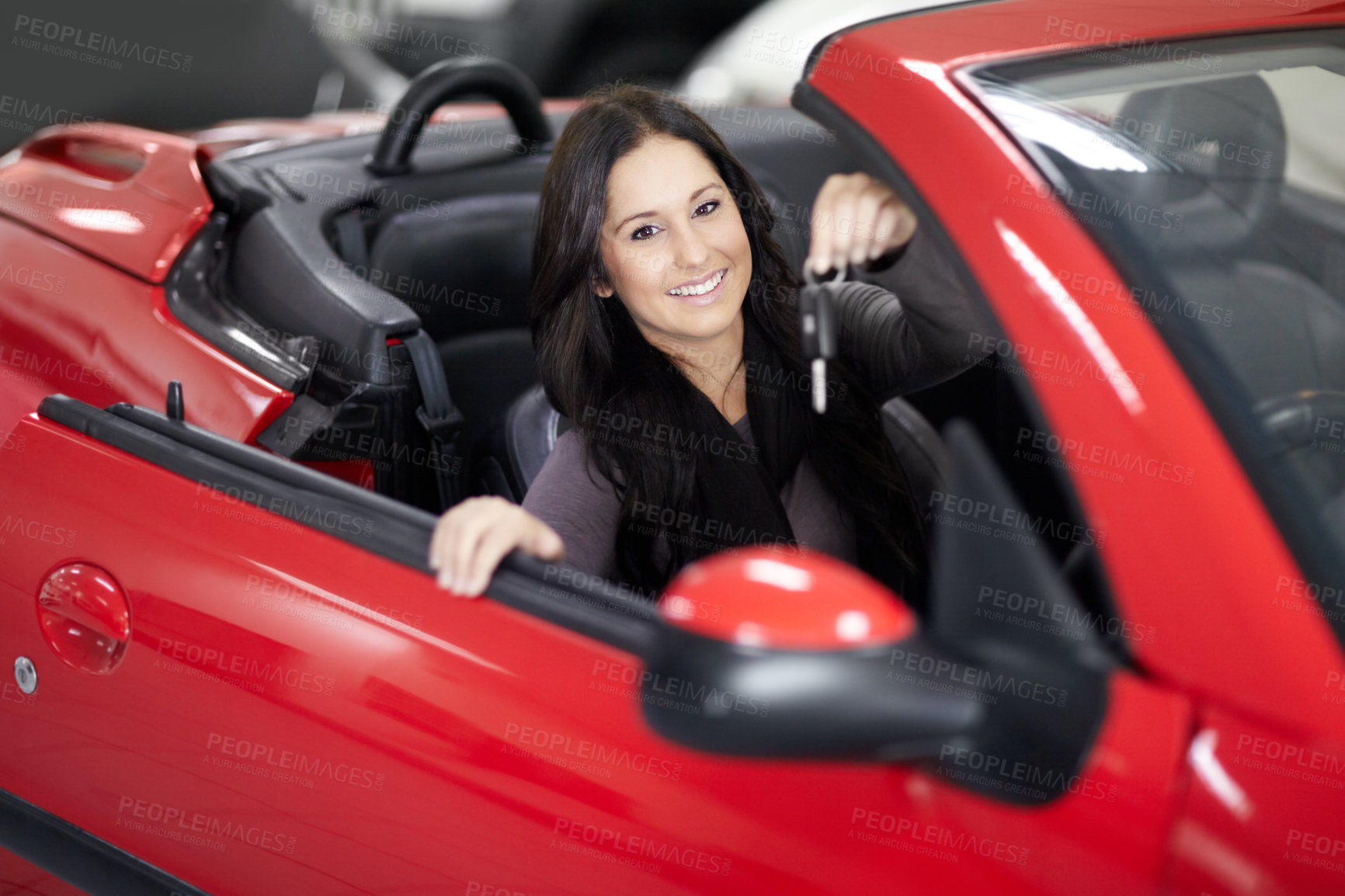 Buy stock photo Key, dealership and portrait of woman in a car for purchase with positive, good or confident attitude. Happy, driving and young female person from Canada in a new vehicle in a showroom for transport.