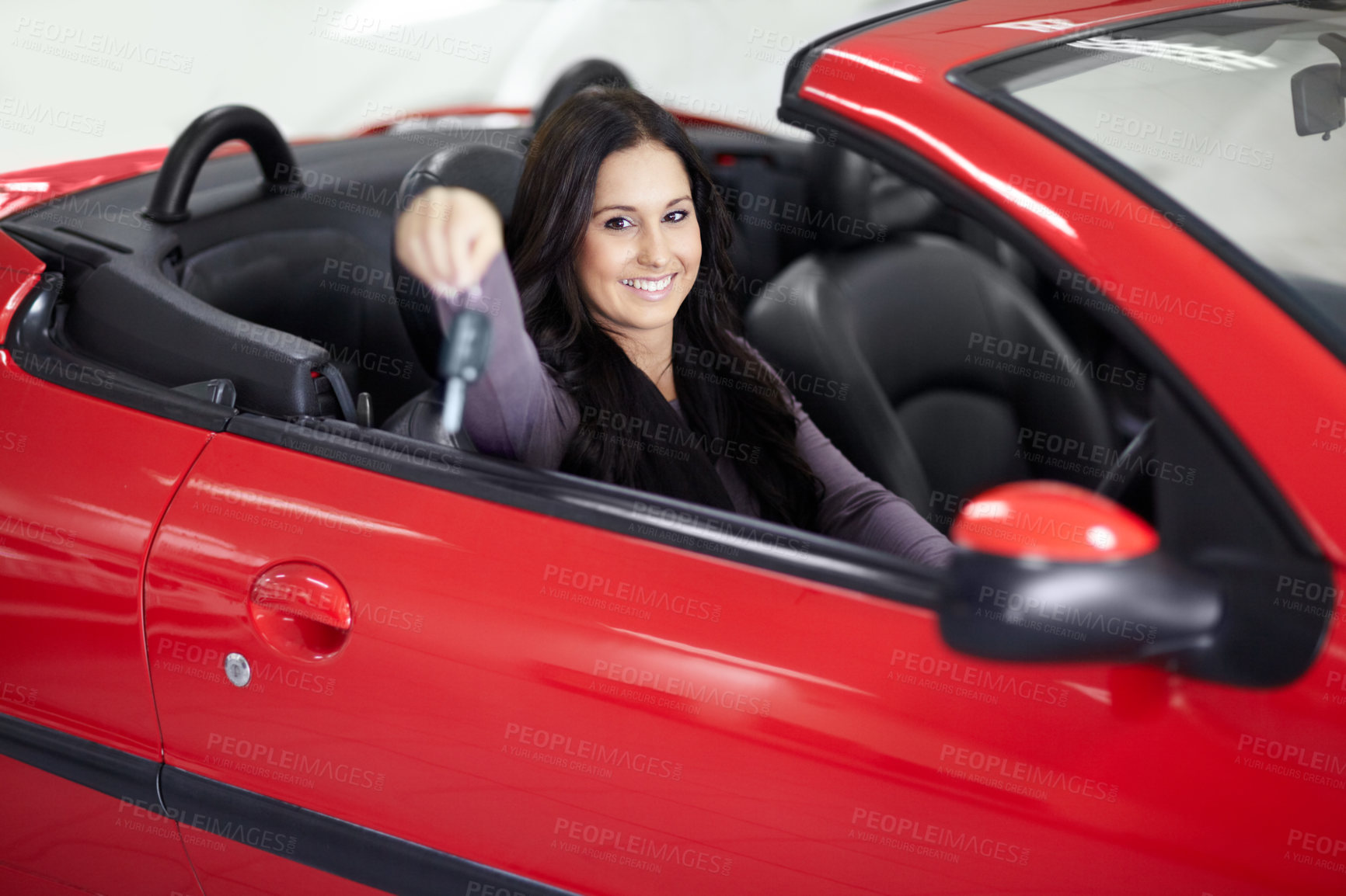 Buy stock photo Key, dealership and portrait of woman in a vehicle for purchase with positive, good or confident attitude. Happy, driving and young female person from Canada in a new car in a showroom for transport.