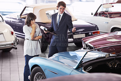 Buy stock photo Car dealership salesman, customer and people consulting on model vehicle, convertible automobile or sales pitch for vintage design. Consultation, transportation choice and seller talking with client