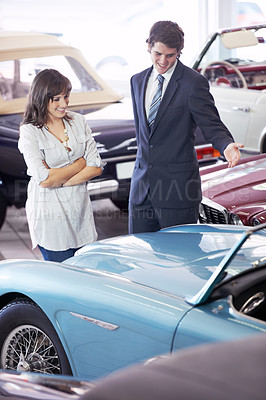 Buy stock photo Car dealership client, happy people and salesman advice on vehicle, auto convertible or sales pitch for retro vintage design. Automobile decision, showroom choice or seller consultation with customer