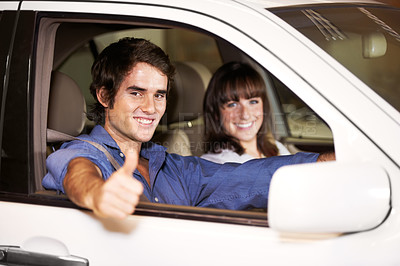 Buy stock photo Smiling young couple seated in their new car