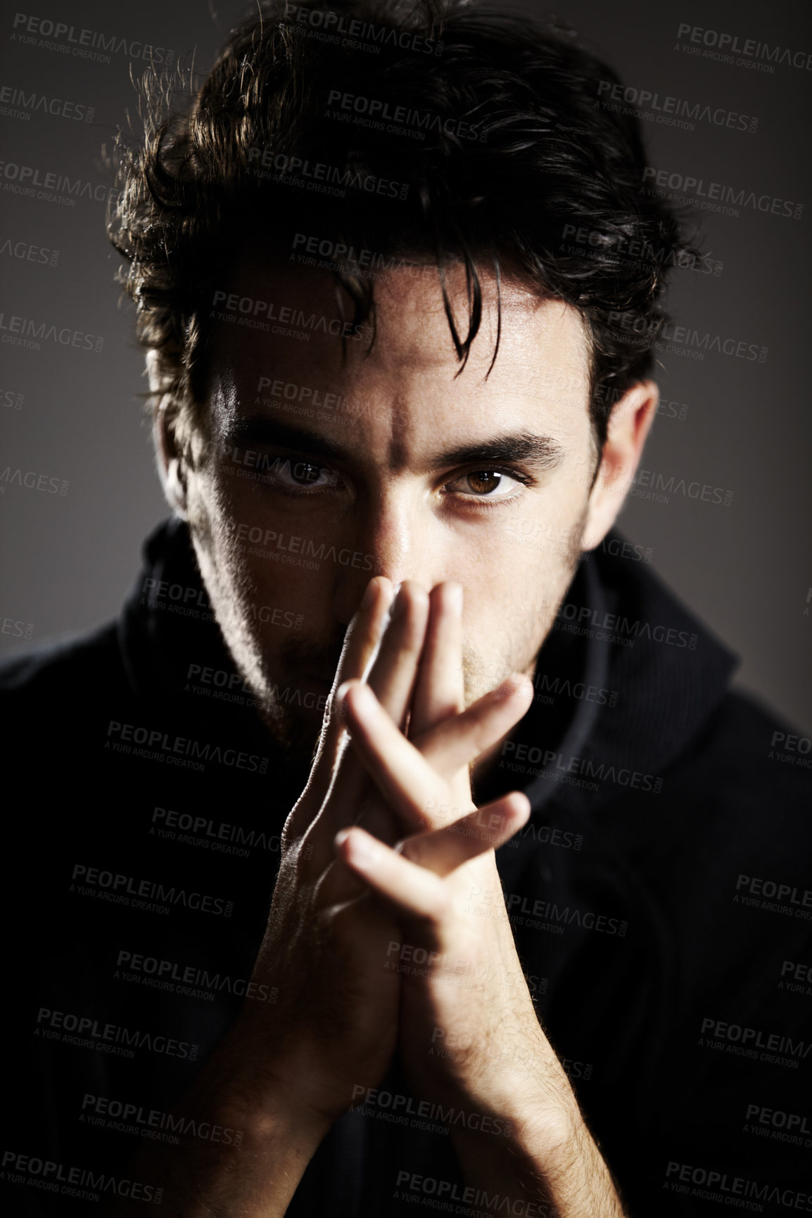 Buy stock photo Dark, mystery and portrait of a man on a black background for agent, detective or spy work. Young, looking and a person with the mafia on a backdrop for a target, fear or staring on a backdrop