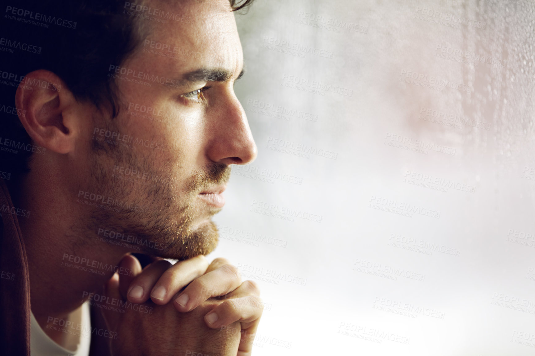 Buy stock photo A young man looking thoughtful as looks into the distance