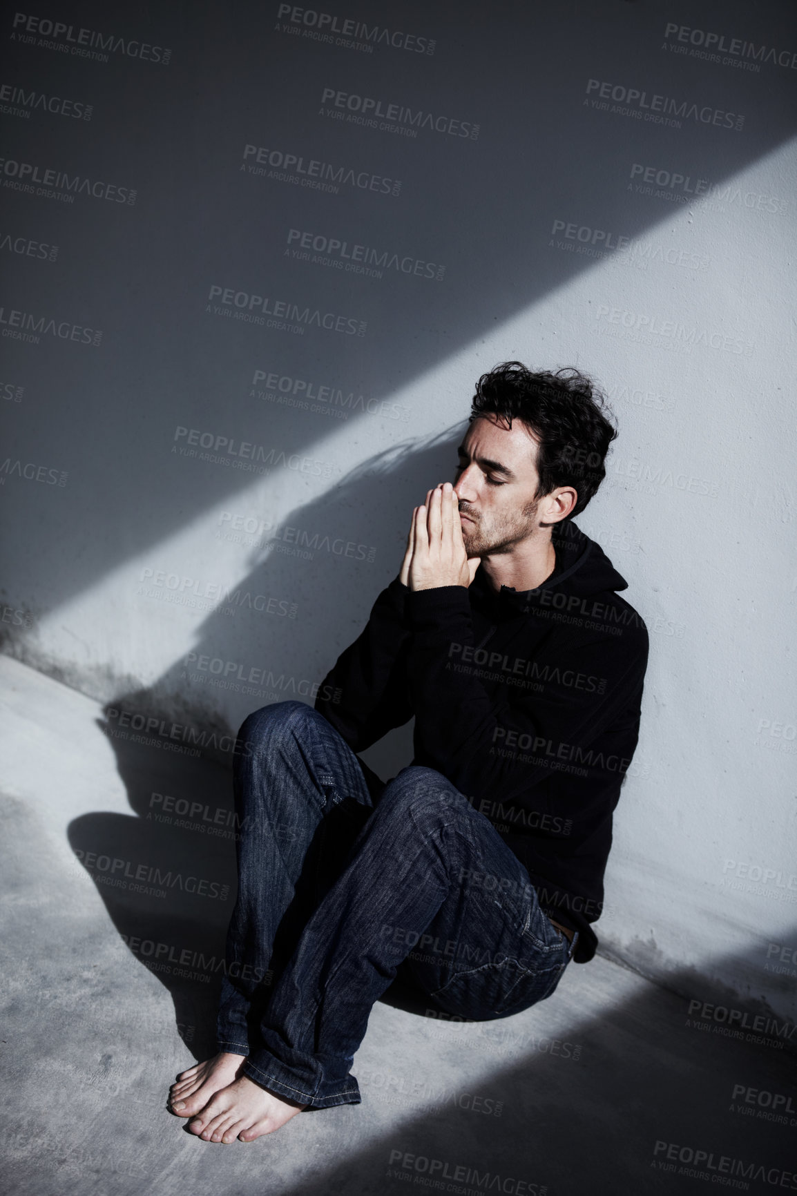 Buy stock photo Man, sad or depression with mental health and pray, stress or burnout, thinking of financial crisis with worship and help. Emotional, praying hands and trauma, bankruptcy or debt with wall background